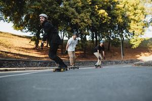 Three charismatic guys ride longboards. Bottom view. photo