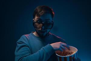 Man with surprised expression and popcorn. Emotion while watching a movie. photo