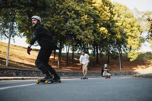 The boys perform tricks and ride. on a skateboard in the evening warm city. photo