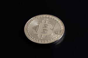Bitcoin on black background. Cryptocurrency trading. Macro photo