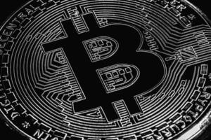 Bitcoin on black background. Cryptocurrency trading. Macro photo