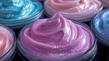 A row of jars with different colored frosting, including pink, purple, and blue photo