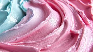 A close up of a pink and blue frosting photo