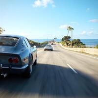 A car driving down the highway with the ocean in the background photo
