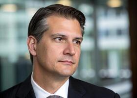 a man in a suit and tie looking off to the side photo