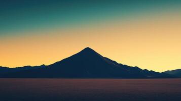 A striking mountain silhouette stands against a vibrant sunset sky. The desert stretches endlessly, creating a sense of peace and vastness. Colors blend beautifully photo