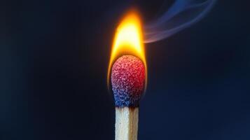 A matchstick with a flame burning on it photo
