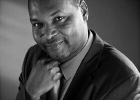 a black and white photo of a man in a suit