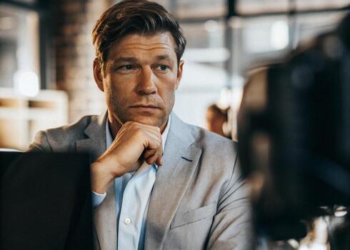 a man in a suit is looking at his computer screen photo