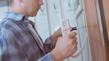 Technician performs diagnostics and configures intercom system, ensuring reliable security for your home. video