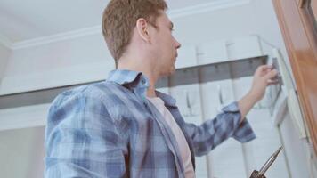 An electrician installs and inspects circuit breakers, ensuring a stable and safe electrical system in the house. video