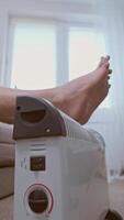 Man uses a heater for warmth during the energy crisis, struggling with energy shortages and rising rates. video