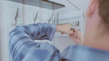 A specialist installs circuit breakers in the panel, ensuring reliable protection of electrical wiring from overloads. video