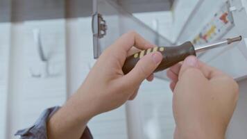 An electrician installs circuit breakers, ensuring protection against short circuits and overloads in the electrical system. video