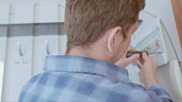Professional installation of circuit breakers in the distribution board for safe electricity use in the home. video