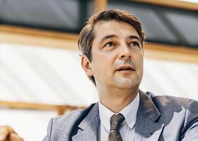 a man in a suit and tie looking up photo