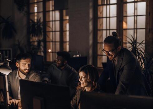 group of people working on computers in an office photo