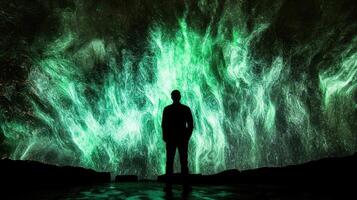 A man standing in front of a green light photo