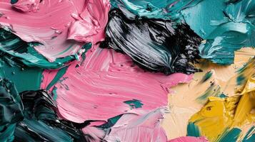 Vibrant abstract art reveals a mix of colors in thick, expressive strokes. The canvas features swirling pink, green, black, and yellow paint, creating a lively texture that captures artistic energy photo