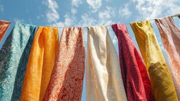 A line of colorful cloths hanging on a clothesline photo