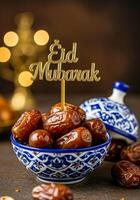 Eid Mubarak Golden Topper with Bowl of Dates on Ornate Blue Ceramic Dish photo