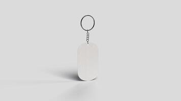 Gray metal keychain suspended in the white backdrop, right view photo