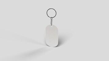 Gray metal keyring suspended in the white backdrop, left view photo