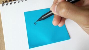 Footage of an illustration of writing the word keep trying on colored paper. Hand activity holding a pen to write the word keep trying video