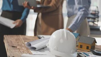 A group of people working on a project with a hard hat video
