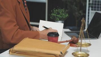 A man in a suit is writing on a piece of paper while sitting at a desk video