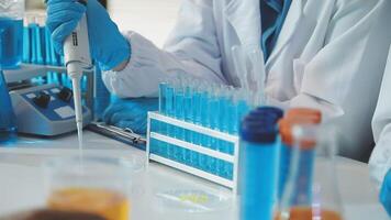 A person in a lab coat is working on a test tube video