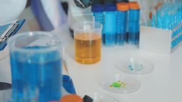 A laboratory table with several test tubes and other items video