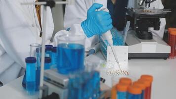 Two people in lab coats are working on a project video