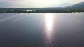 Aerial View of Serene Lake with Sunlight Reflection video