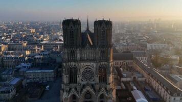 Drone flyover between the towers of Notre Dame in Reims at dawn video