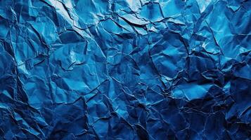 Crumpled blue paper background with a blue color photo