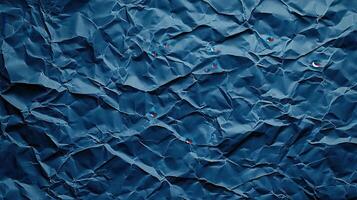 Crumpled blue paper background with red dots photo