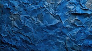 Crumpled blue paper background with a blue color photo