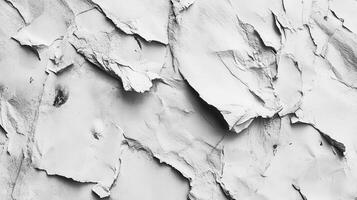 A black and white photo of a wall with peeling paint