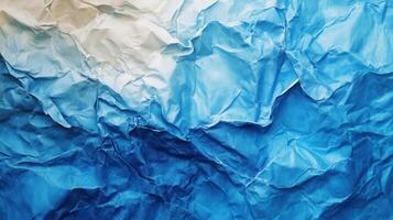 Crumpled paper background with blue and white crumpled paper photo