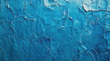 A blue wall with peeling paint and cracks photo