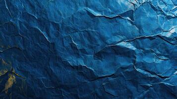 Crumpled blue paper background with a gold foil photo