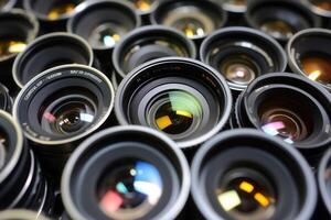 A collection of camera lenses arranged closely together. photo