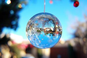 A reflective ornament hanging outdoors, capturing scenery. photo