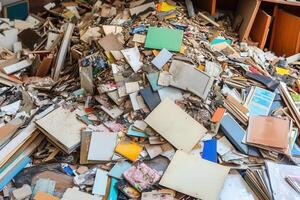 A cluttered pile of discarded books and papers. photo