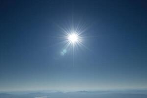 Bright sun shining in a clear blue sky. photo