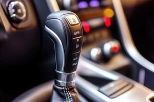 Close-up of a car's gear shift lever and controls. photo