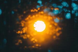 Blurred sunset through foliage creating a warm glow. photo