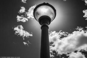 A vintage street lamp silhouetted against the sky. photo