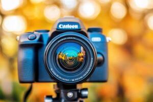Camera with lens against a blurred autumn background. photo